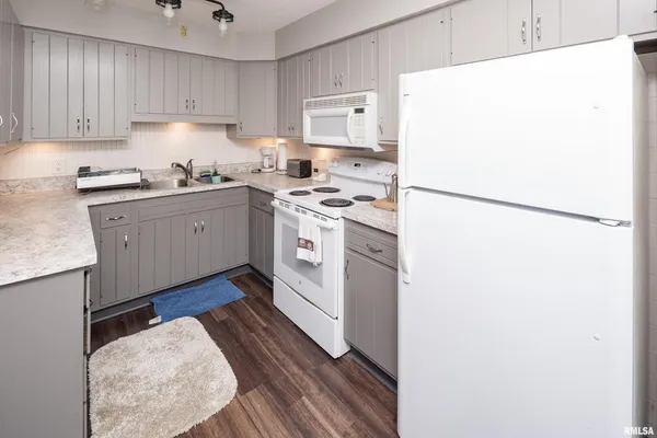a kitchen with a refrigerator sink stove and cabinets