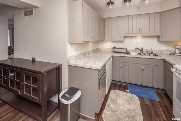 a kitchen with stainless steel appliances granite countertop a sink stove and cabinets