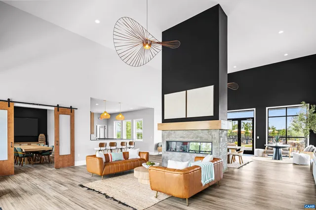 a living room with furniture bathtub and a flat screen tv