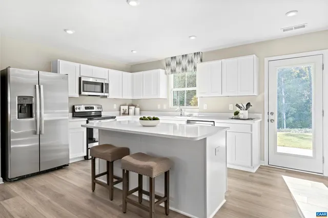 a kitchen with a sink a window and cabinets