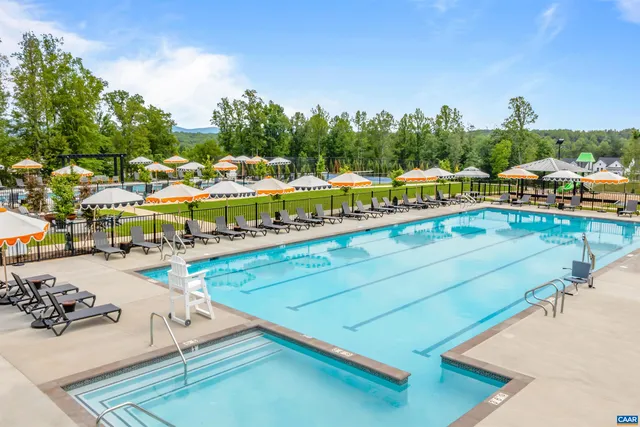 a view of a swimming pool with lawn chairs