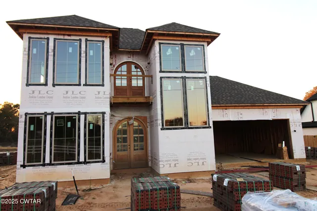 a front view of a house with parking space