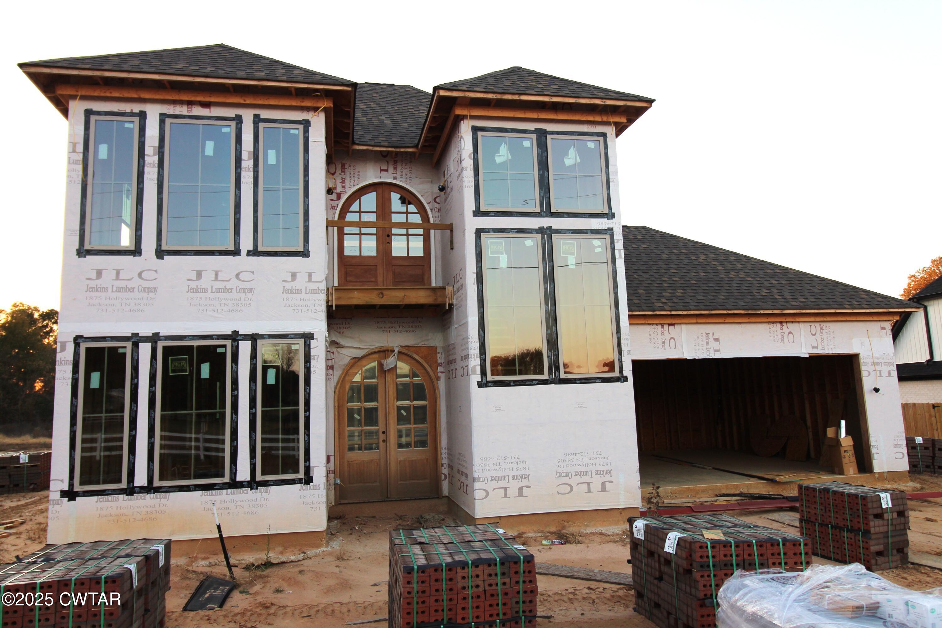 a front view of a house with parking space