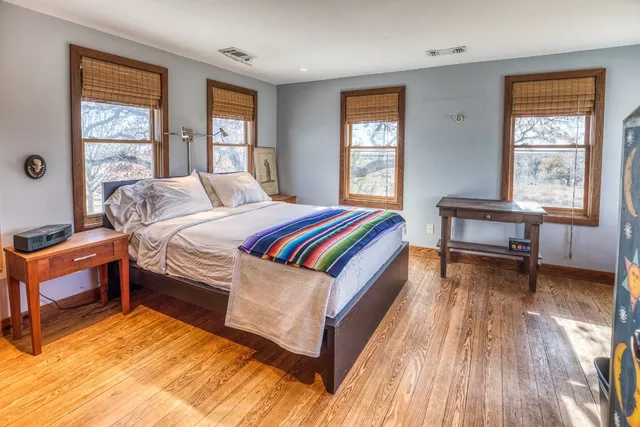 a bed room with a bed and a chair