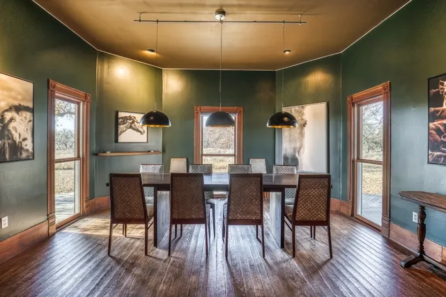 a view of a a dining room with furniture window and wooden floor