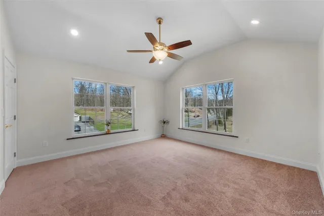 an empty room with windows and closet