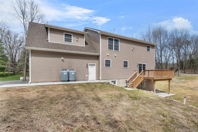 a view of a house with backyard and sitting area