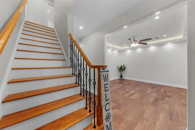 a view of entryway and hall with wooden floor