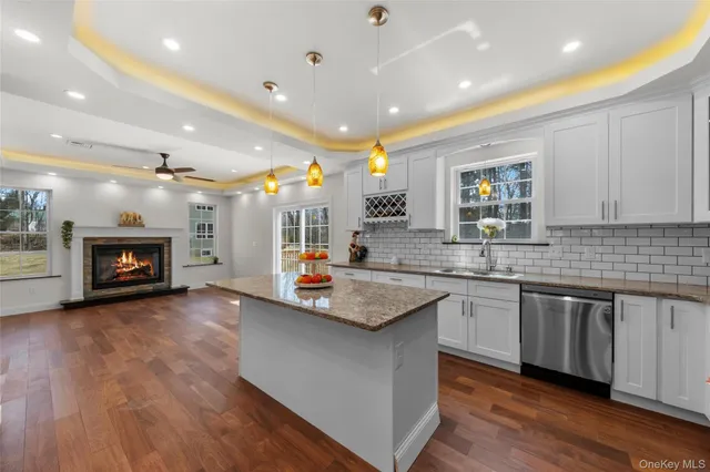 a kitchen with sink stove and wooden floor