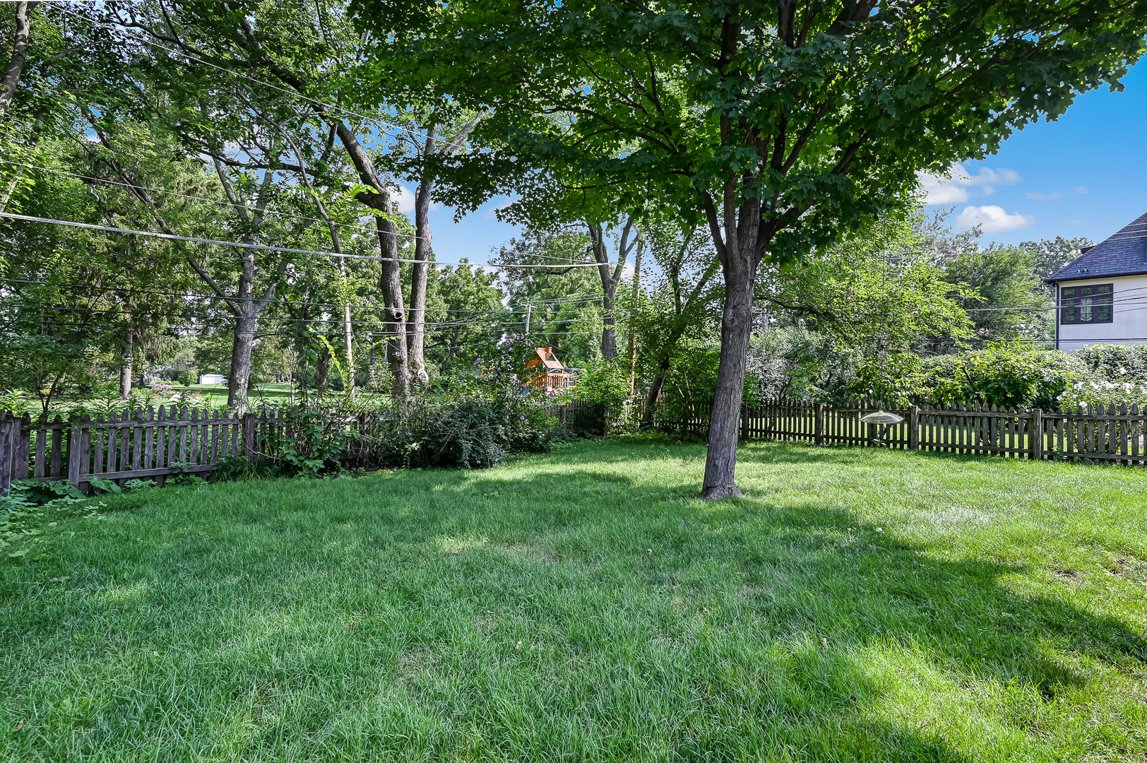 440 East Naperville Road Clarendon Hills, IL 60514 - Photo 21 of 23 a view of a grassy field with trees in the background