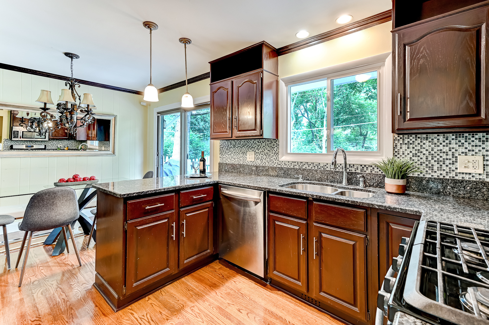 440 East Naperville Road Clarendon Hills, IL 60514 - Photo 8 of 23 a kitchen with stainless steel appliances granite countertop a sink and wooden cabinets