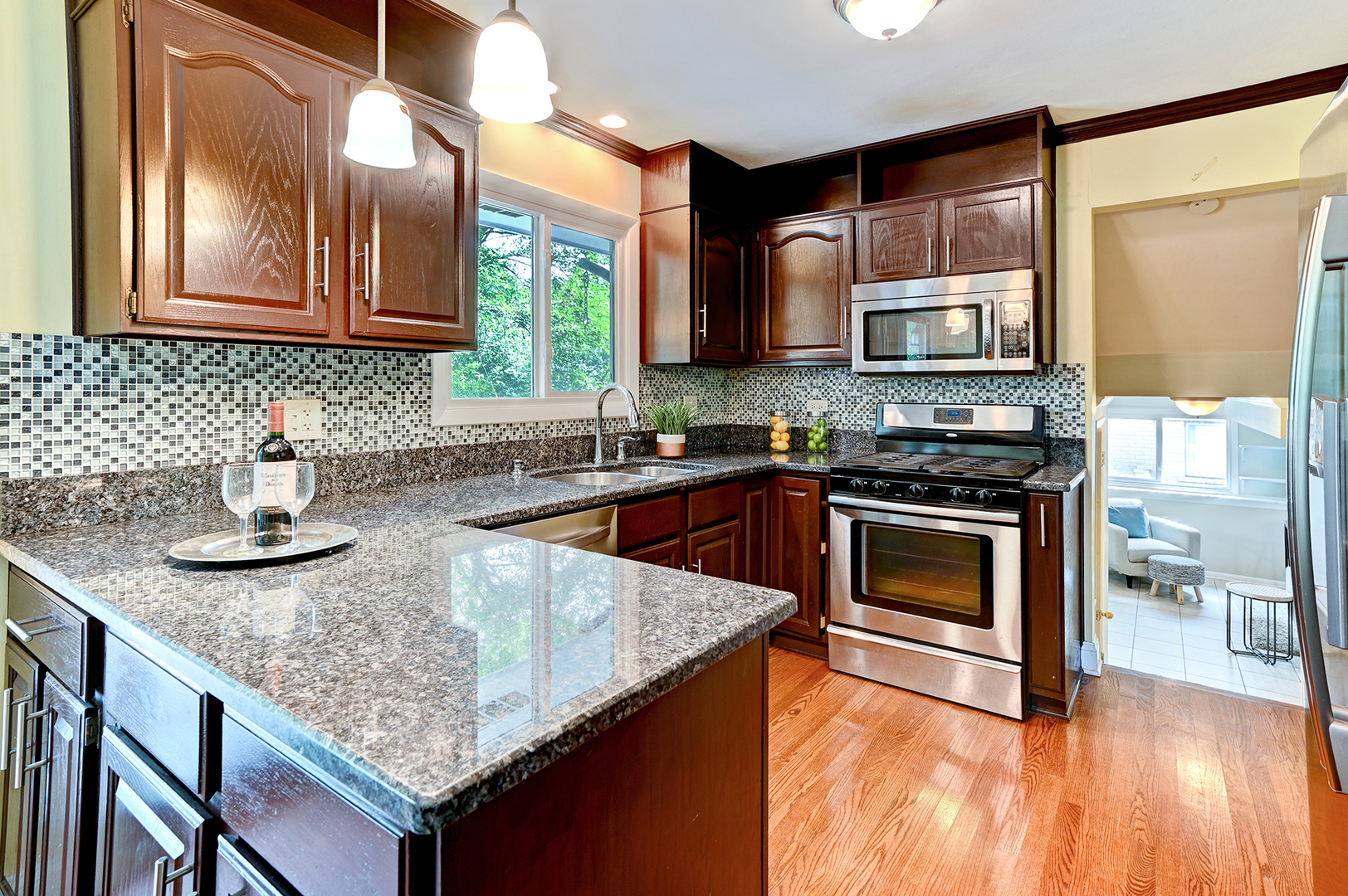 440 East Naperville Road Clarendon Hills, IL 60514 - Photo 9 of 23 a kitchen with stainless steel appliances granite countertop a sink stove and microwave