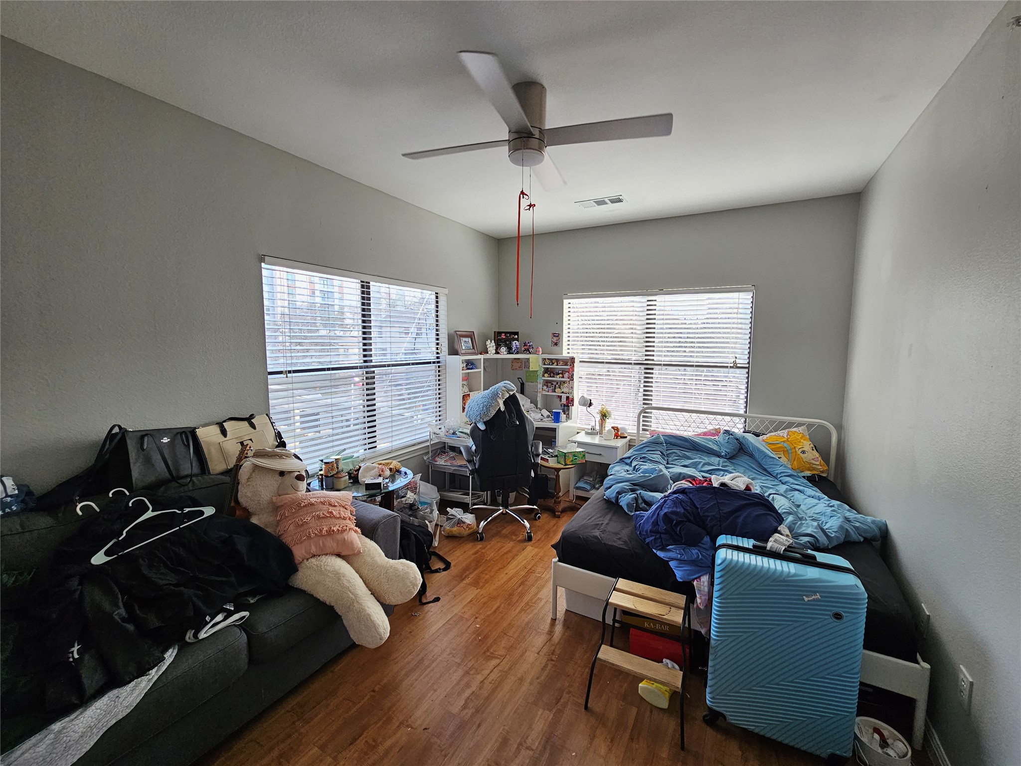 2502 Leon Street, Unit 304 Austin, TX 78705 - Photo 4 of 10 Bedroom with wood finished floors and ceiling fan