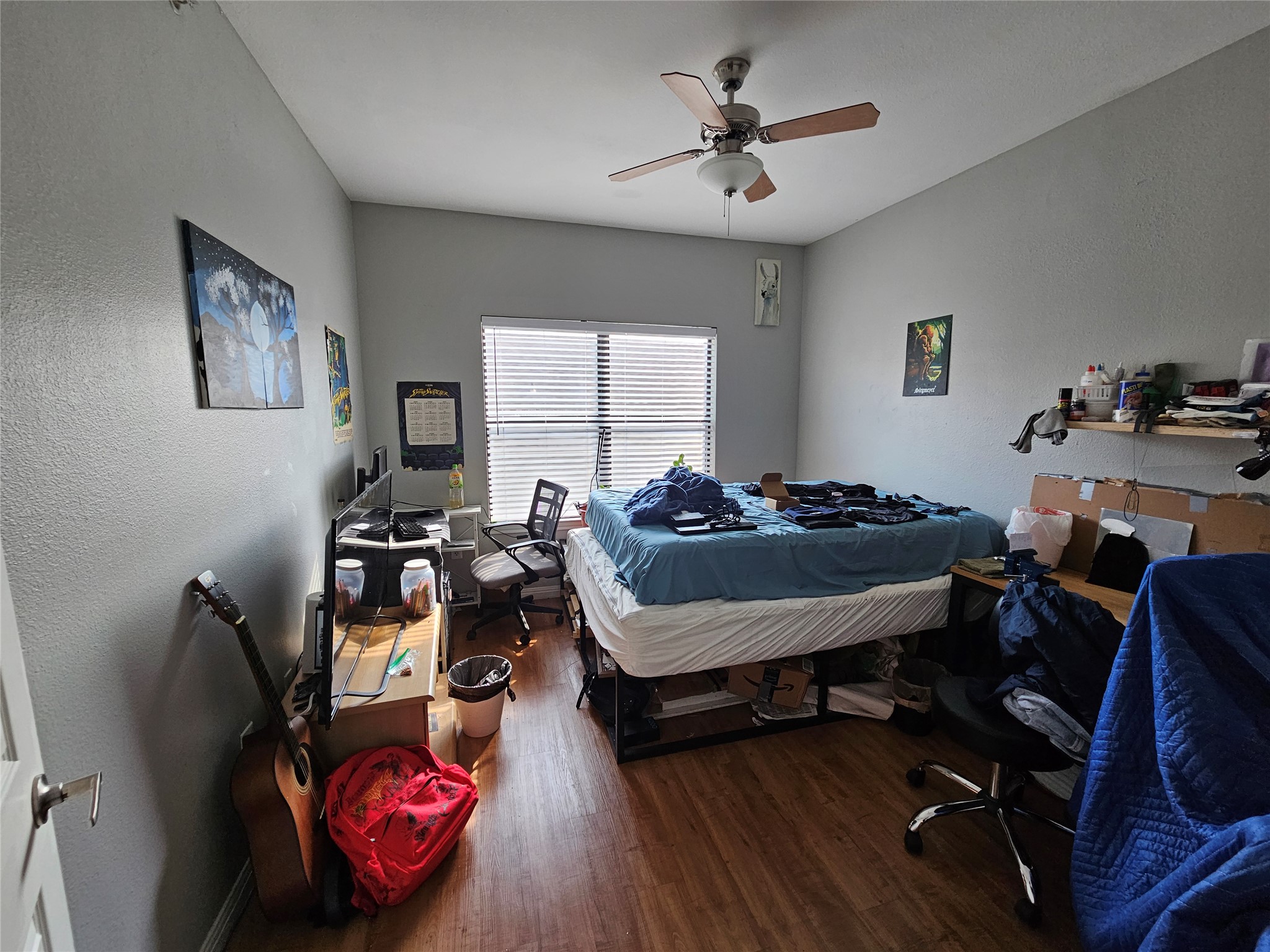 2502 Leon Street, Unit 304 Austin, TX 78705 - Photo 7 of 10 Bedroom featuring a desk, a textured wall, dark wood-style flooring, and ceiling fan