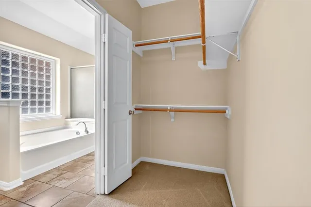 an empty room with a empty space and chandelier fan