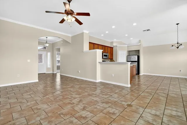 a kitchen with stainless steel appliances granite countertop a stove a sink a refrigerator and a cabinets