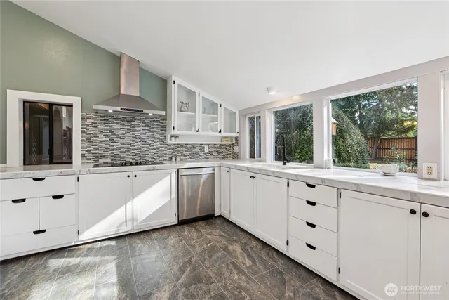 a kitchen with granite countertop white cabinets and white appliances
