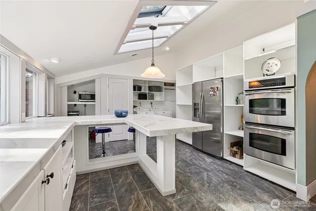 a kitchen with stainless steel appliances granite countertop a sink stove and refrigerator