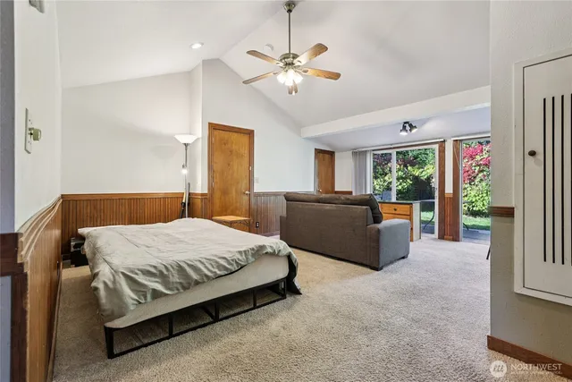 a bedroom with a large bed and a chandelier