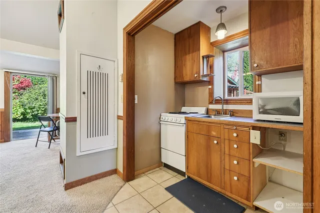 a kitchen with stainless steel appliances granite countertop a refrigerator and a stove
