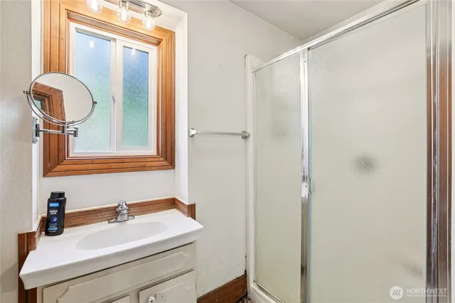 a bathroom with a sink vanity and a mirror