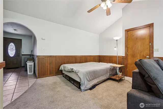 a bedroom with a bed and a chandelier