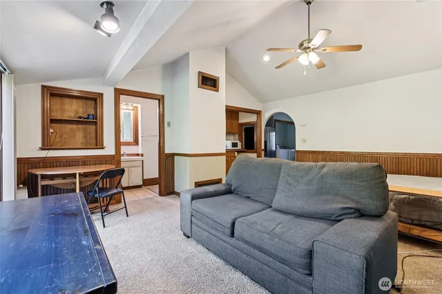a living room with furniture and a dining table