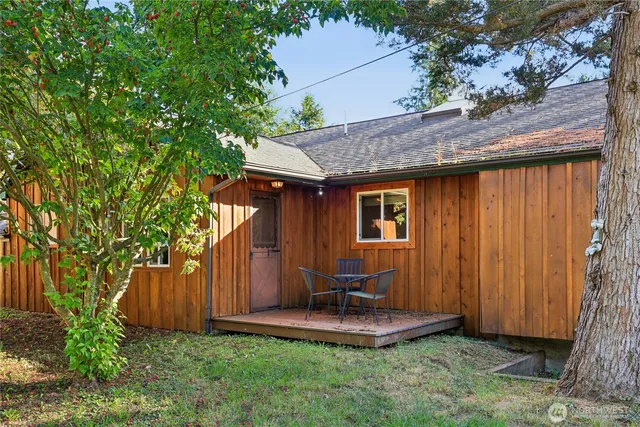 a backyard of a house with table and chairs