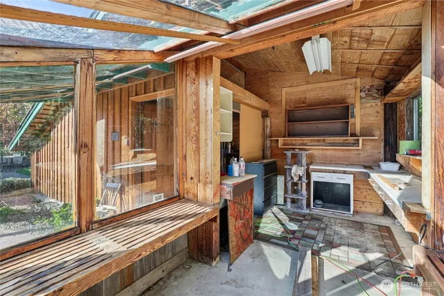 a view of a porch with furniture and a fireplace