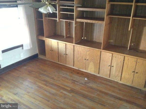 106 Riverthorn Road Baltimore, MD 21220 - Photo 4 of 18 a view of an empty room with wooden floor