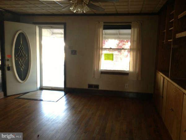 106 Riverthorn Road Baltimore, MD 21220 - Photo 5 of 18 a view of a room with wooden floor and windows