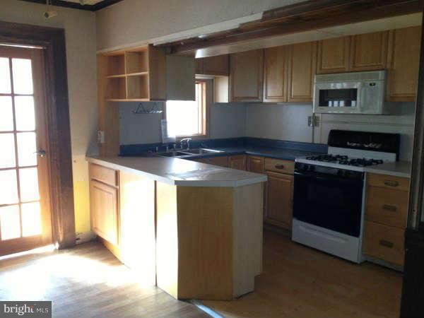 106 Riverthorn Road Baltimore, MD 21220 - Photo 8 of 18 a kitchen with a stove and a white cabinet
