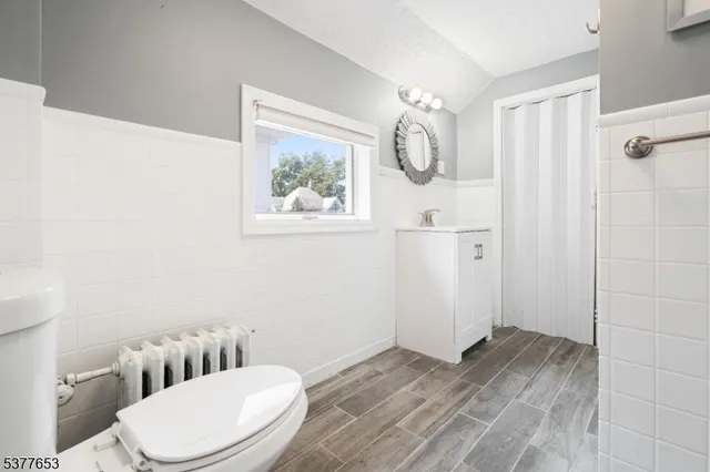 a white toilet sitting next to a bathroom sink