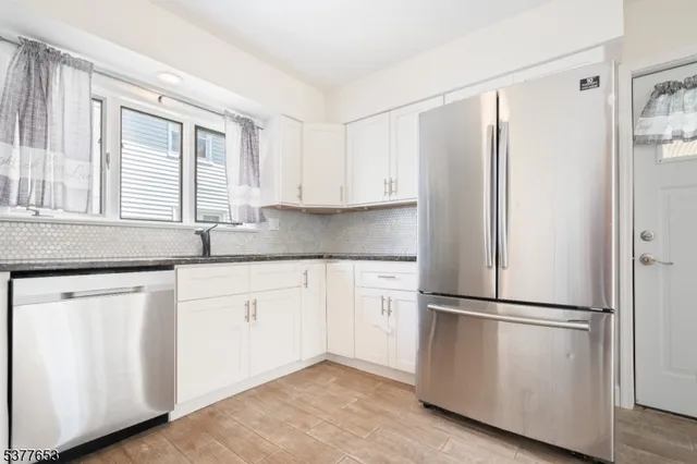 a kitchen with appliances cabinets and a sink