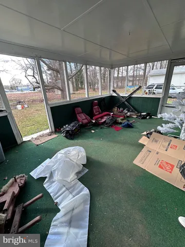 a view of a room with furniture and a large window