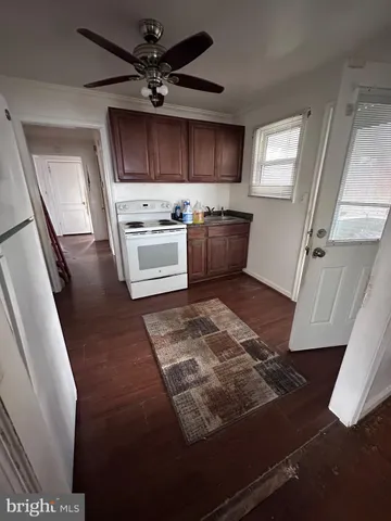 a kitchen with stainless steel appliances a stove a sink a microwave a refrigerator and cabinets