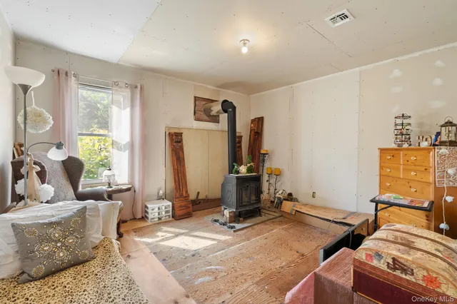 a bedroom with furniture and a flat screen tv