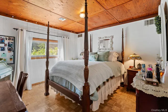 a bedroom with a bed and a chair