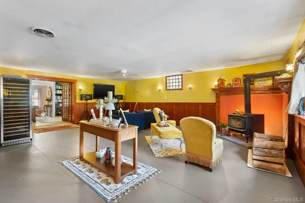 a living room with furniture and a floor to ceiling window