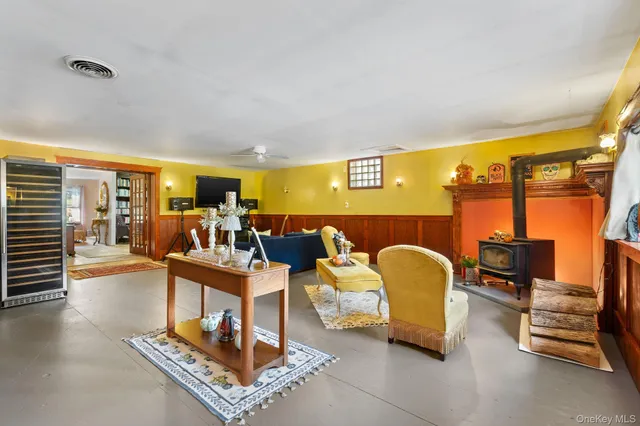 a living room with furniture and a floor to ceiling window