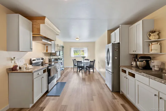 a kitchen with stainless steel appliances a stove a sink and a refrigerator