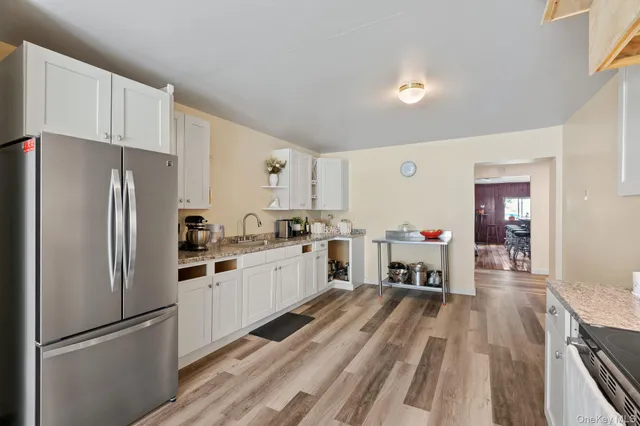 a kitchen with white cabinets and stainless steel appliances