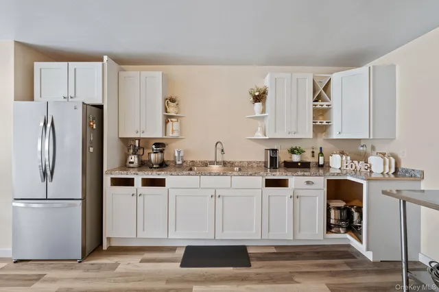 a kitchen with stainless steel appliances a sink stove and cabinets