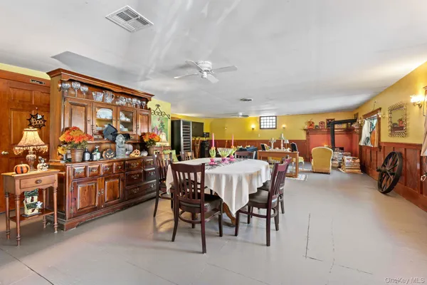 a view of a dining room with furniture and a large window