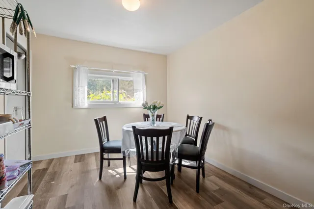 a kitchen with a table chairs and a floor to ceiling window