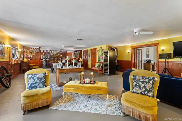 a living room with furniture and a dining table with wooden floor