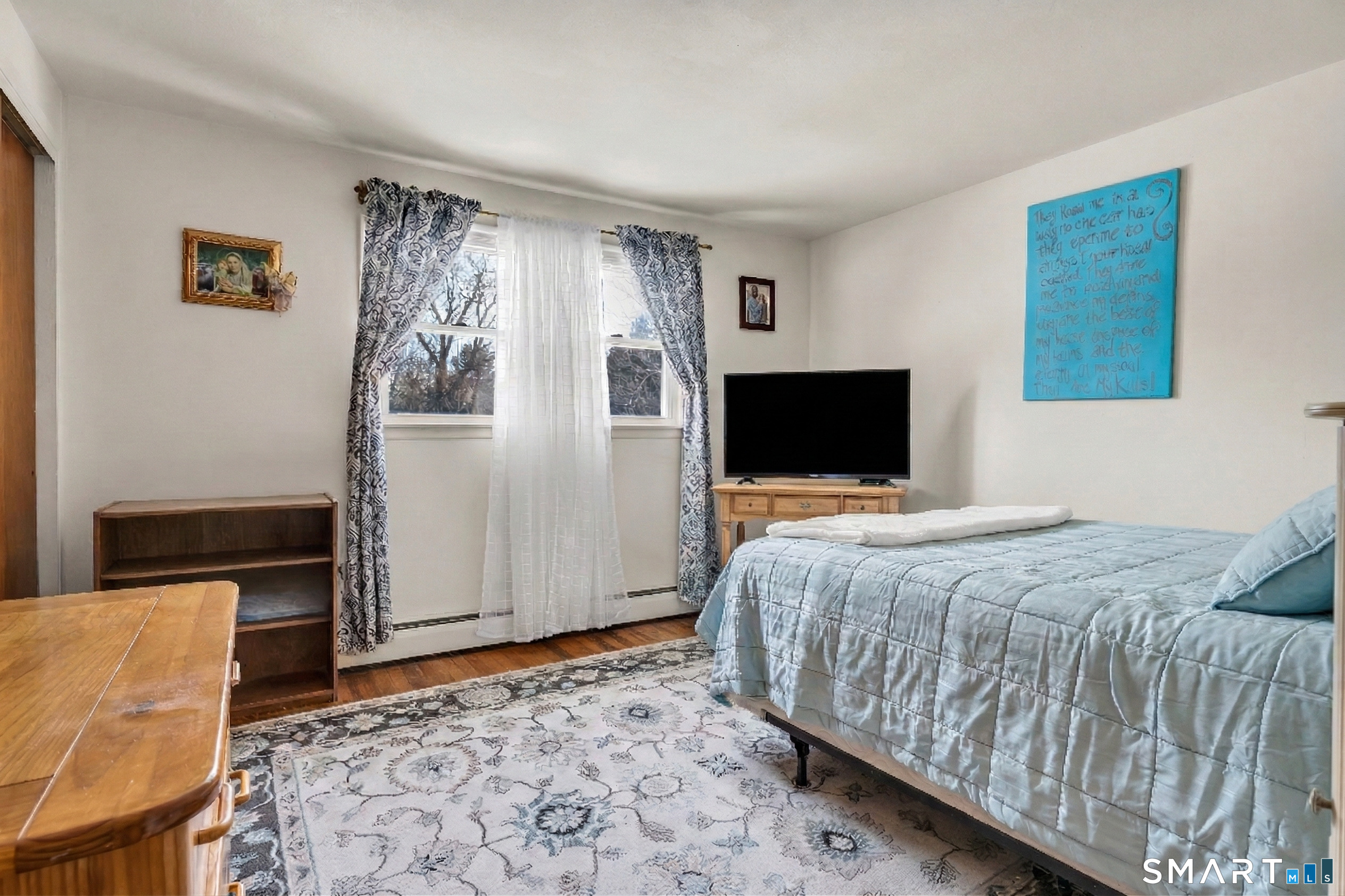 144 East Main Street, Unit 5 Clinton, CT 06413 - Photo 12 of 26 a bedroom with a bed and flat screen tv