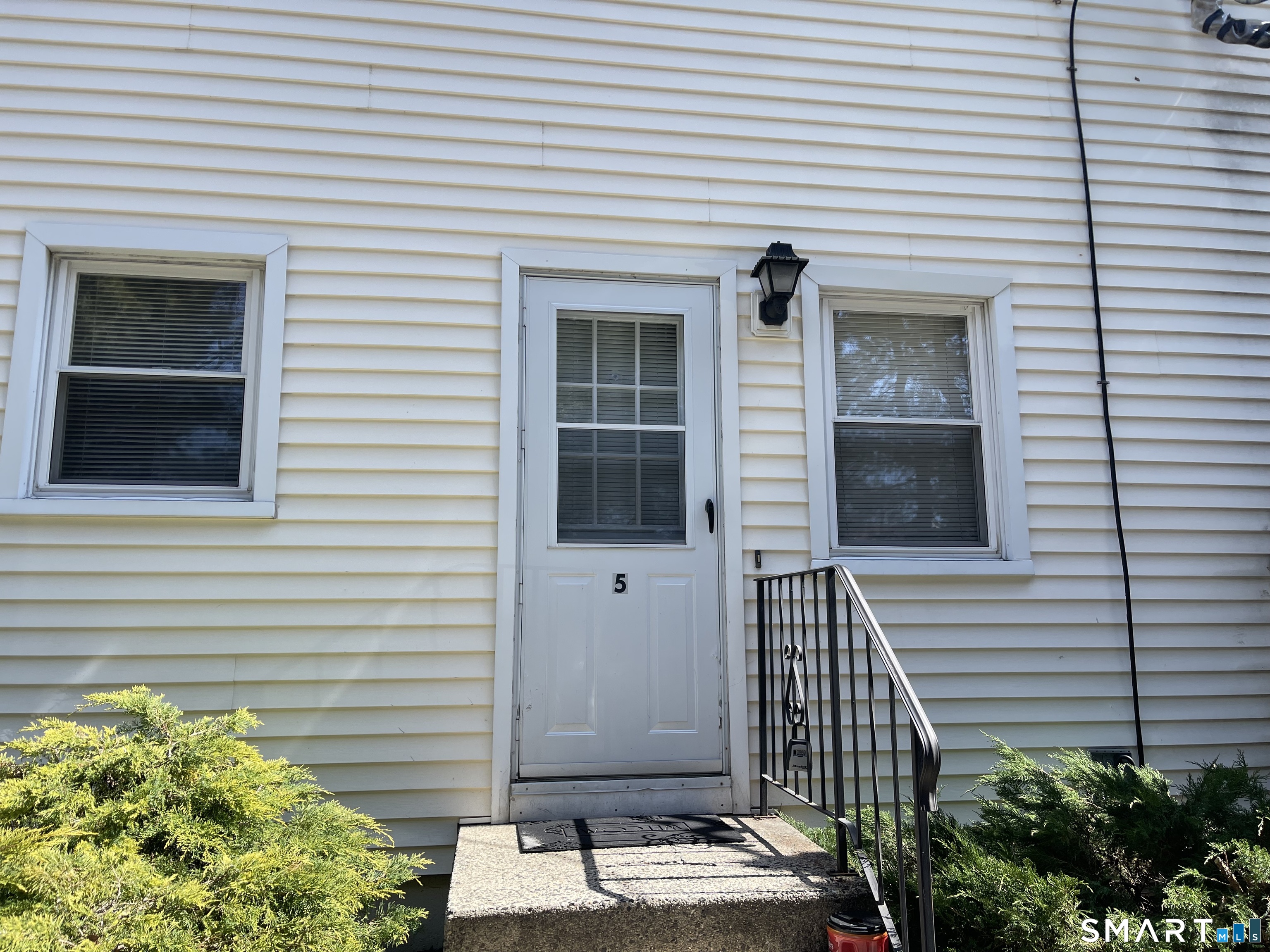 144 East Main Street, Unit 5 Clinton, CT 06413 - Photo 19 of 26 a view of a house with a door and a tree