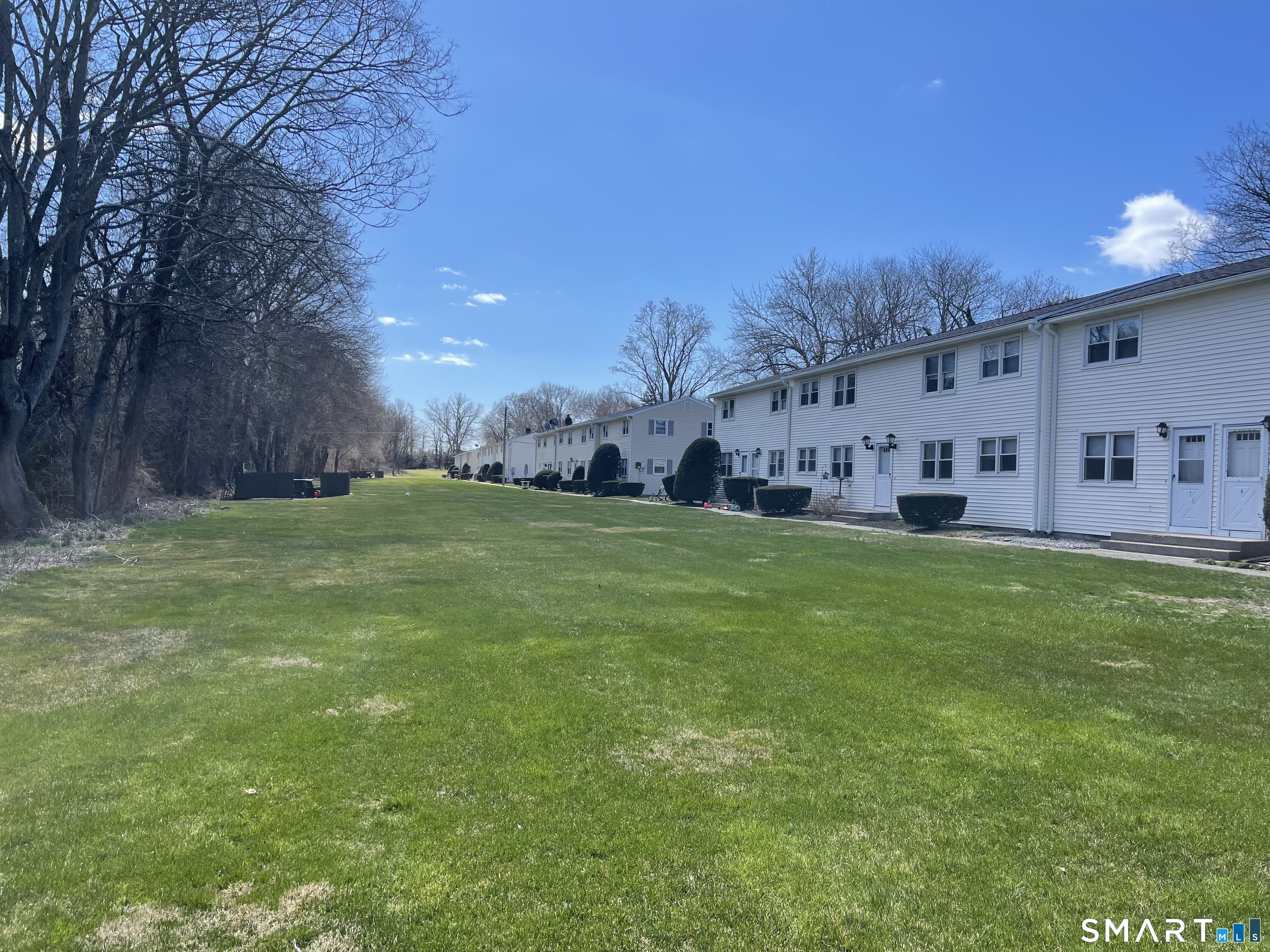 144 East Main Street, Unit 5 Clinton, CT 06413 - Photo 22 of 26 a view of a big yard with a large tree