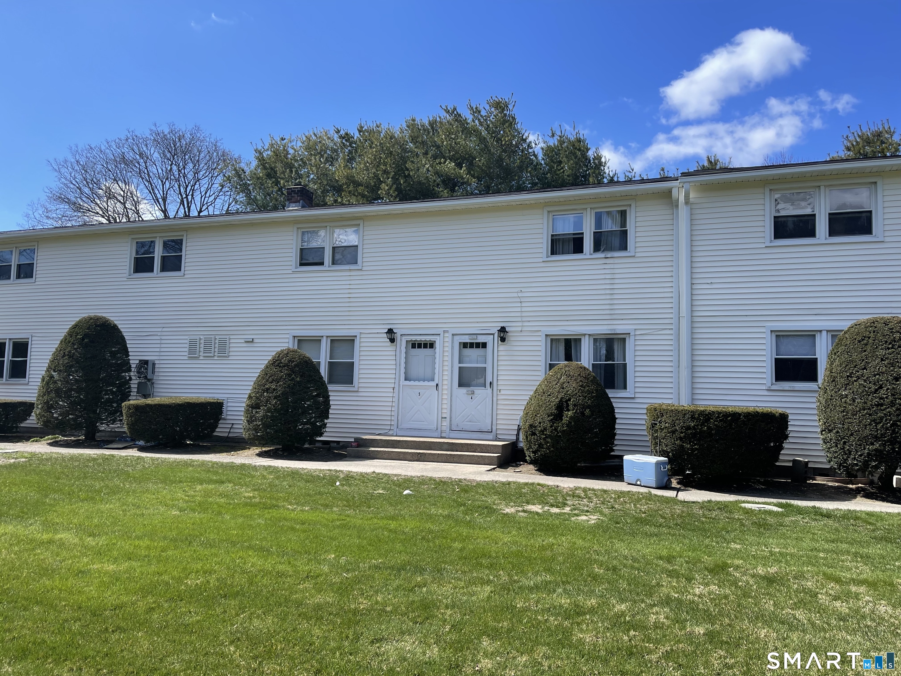 144 East Main Street, Unit 5 Clinton, CT 06413 - Photo 4 of 26 a front view of a house with a garden